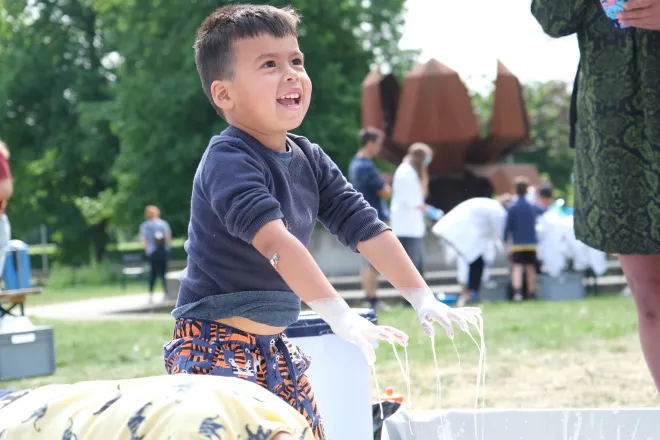 Boy playing with non-Newtonian liquid